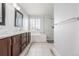 Bathroom featuring double vanity, soaking tub, glass enclosed shower, and decorative tile accents at 364 Willowick Cir, Highlands Ranch, CO 80129