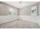 Carpeted room with wainscotting, crown molding, and natural light from two windows at 364 Willowick Cir, Highlands Ranch, CO 80129