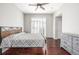 The primary bedroom includes hardwood floors, a modern bed, and a large window with plantation shutters at 364 Willowick Cir, Highlands Ranch, CO 80129