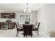 This dining area features a wood table with seating for four, a modern chandelier, and large windows with stylish shutters at 364 Willowick Cir, Highlands Ranch, CO 80129