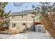 Backyard view of two-story home with patio, shed, balcony, gray siding and sliding glass doors at 364 Willowick Cir, Highlands Ranch, CO 80129