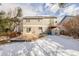 Exterior view of a two-story home and partially snow covered yard at 364 Willowick Cir, Highlands Ranch, CO 80129