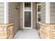 Detailed front entrance featuring stone pillar accents and a stylish black front door at 364 Willowick Cir, Highlands Ranch, CO 80129