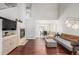 Open-concept living room with hardwood floors, a fireplace, and ample natural light at 364 Willowick Cir, Highlands Ranch, CO 80129