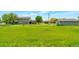 Spacious backyard featuring lush green grass, mature trees, and a back deck on the home at 15545 Lipan St, Broomfield, CO 80023
