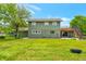 Expansive backyard features a two-story home with a deck and staircase, set against a lush green lawn at 15545 Lipan St, Broomfield, CO 80023