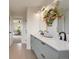 A neutral bathroom features a dual-sink vanity with floral decor accents at 15545 Lipan St, Broomfield, CO 80023