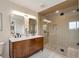Modern bathroom featuring a double vanity with a marble countertop and a luxurious walk-in shower at 15545 Lipan St, Broomfield, CO 80023