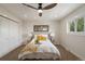 Bright bedroom featuring a ceiling fan, hardwood floors, and natural light from the window at 15545 Lipan St, Broomfield, CO 80023