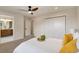 Cozy bedroom featuring a white comforter and hardwood floors, with bathroom access at 15545 Lipan St, Broomfield, CO 80023