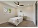 Bright bedroom with a ceiling fan, a large window, neutral carpet, and a closet for storage at 15545 Lipan St, Broomfield, CO 80023