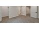 Neutral bedroom with carpet and white trim with white doors and open closets at 15545 Lipan St, Broomfield, CO 80023