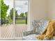 Light-filled bedroom featuring a sitting area with chairs and a view of the backyard deck at 15545 Lipan St, Broomfield, CO 80023