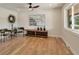 Relaxing bonus room featuring hardwood floors, a ceiling fan, and natural light at 15545 Lipan St, Broomfield, CO 80023