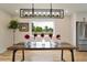 Contemporary dining room with a large window and stylish modern light fixture above a wooden table at 15545 Lipan St, Broomfield, CO 80023