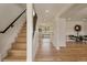 Bright foyer with hardwood floors, staircase, and views into the dining area, creating a welcoming entrance at 15545 Lipan St, Broomfield, CO 80023