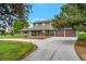 Beautiful two-story home on a sunny day, with green lawn and curved driveway at 15545 Lipan St, Broomfield, CO 80023