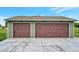 Spacious three-car garage features modern wood doors and extra lighting at 15545 Lipan St, Broomfield, CO 80023