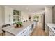 Bright kitchen featuring a large center island, stainless steel appliances, and hardwood floors at 15545 Lipan St, Broomfield, CO 80023