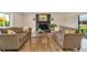 Cozy living room with a black brick fireplace, hardwood floors, and comfortable seating at 15545 Lipan St, Broomfield, CO 80023