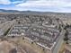 Aerial view of a townhome community with surrounding landscape and mountains in the background at 9711 W Indore Dr, Littleton, CO 80128