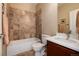 Clean bathroom with tile flooring, shower/tub combo, and updated vanity at 9711 W Indore Dr, Littleton, CO 80128