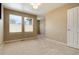 Well-lit secondary bedroom with neutral wall colors and carpet at 9711 W Indore Dr, Littleton, CO 80128