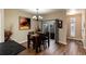 Dining area with table and chairs, hardwood floors, and access to a patio at 9711 W Indore Dr, Littleton, CO 80128