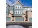 Two-story townhome with attached garage and light teal siding at 9711 W Indore Dr, Littleton, CO 80128