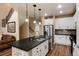 Modern kitchen with white cabinets, a large island, and stainless steel appliances at 9711 W Indore Dr, Littleton, CO 80128