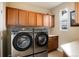 Convenient laundry room with modern washer and dryer, and plenty of cabinet storage at 9711 W Indore Dr, Littleton, CO 80128