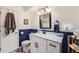 Updated bathroom featuring a modern vanity, stylish mirror and contrasting wall colors at 7695 E Quincy Ave # 105, Denver, CO 80237