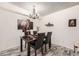 Elegant dining area featuring a chandelier, sleek black table and modern decor at 7695 E Quincy Ave # 105, Denver, CO 80237