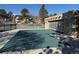 Community pool area featuring a large pool with safety cover, tennis courts, and clubhouse with roll-up door at 7695 E Quincy Ave # 105, Denver, CO 80237