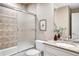 Clean bathroom with shower/tub combo, granite countertop, and updated fixtures at 2 Garfield St # B, Denver, CO 80206