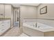 Elegant bathroom with corner tub, granite vanity, and tiled floors at 2 Garfield St # B, Denver, CO 80206