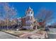 Brick three-story townhouse with unique architectural details and landscaping at 2 Garfield St # B, Denver, CO 80206