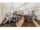 Open concept kitchen and dining area with hardwood floors and modern lighting fixtures at 2 Garfield St # B, Denver, CO 80206