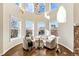Sunroom with two armchairs, a small table, and large windows at 2 Garfield St # B, Denver, CO 80206