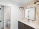 Bathroom featuring a vanity with tile backsplash, modern fixtures, and a walk-in closet at 5392 Lions Paw St, Castle Rock, CO 80104