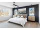 Cozy primary bedroom with large windows, dark accent wall, and stylish décor at 5392 Lions Paw St, Castle Rock, CO 80104