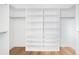 Spacious walk-in closet with custom shelving and wood flooring at 5392 Lions Paw St, Castle Rock, CO 80104