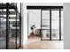 Modern dining area featuring glass doors, hardwood floors, and stylish design at 5392 Lions Paw St, Castle Rock, CO 80104