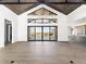 Expansive great room features vaulted ceilings, large windows, and a modern chandelier at 5392 Lions Paw St, Castle Rock, CO 80104