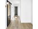 Bright hallway featuring hardwood floors and contrasting modern accents at 5392 Lions Paw St, Castle Rock, CO 80104