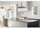 Modern kitchen with large island, stainless steel appliances, and stylish pendant lighting at 5392 Lions Paw St, Castle Rock, CO 80104