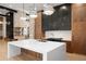Modern kitchen with a large island, granite countertops, and stainless steel appliances at 5392 Lions Paw St, Castle Rock, CO 80104