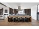 Open kitchen with eat-in island, modern appliances, and access to the living area at 5392 Lions Paw St, Castle Rock, CO 80104