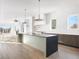Spacious open concept kitchen with stone countertops, stainless steel appliances, and custom cabinets at 5392 Lions Paw St, Castle Rock, CO 80104