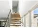 Contemporary staircase featuring wood treads and iron railing with light filled windows at 5392 Lions Paw St, Castle Rock, CO 80104